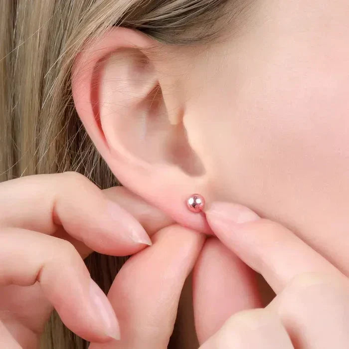 a young lady wearing 14K Gold Ball Earring Studs