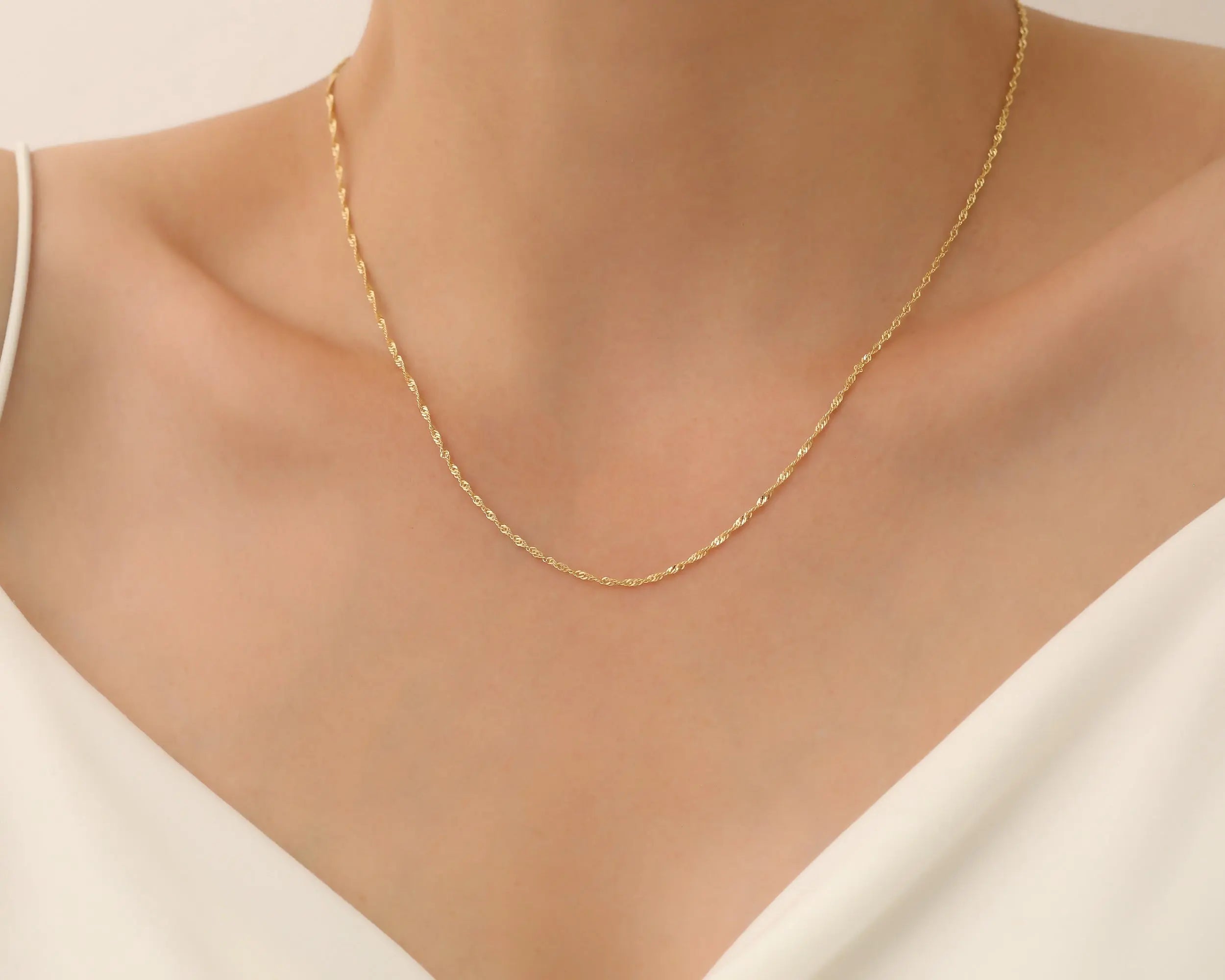 a young lady wearing Gold Chain Necklace
