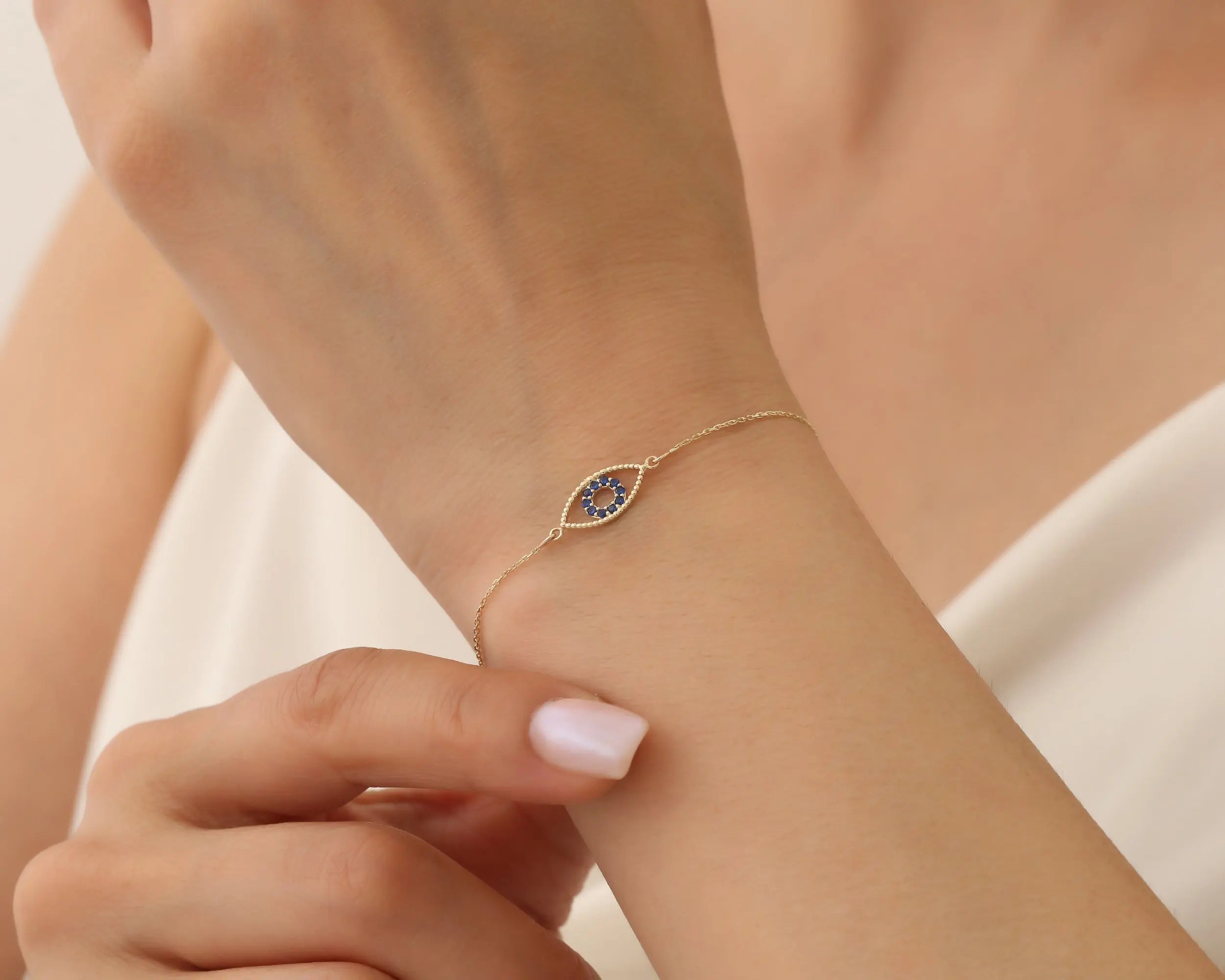 a young lady wearing Evil eye bracelet in her wrist