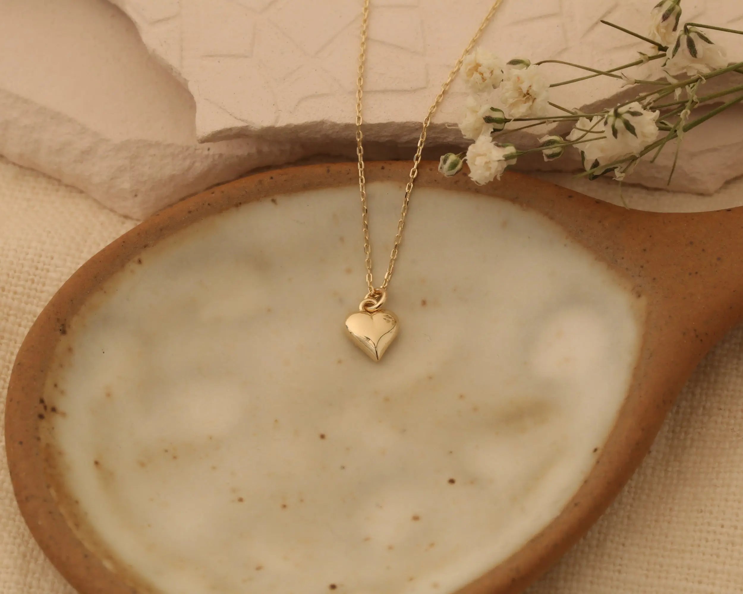 lady holding 14K Gold Heart Necklace and Bracelet